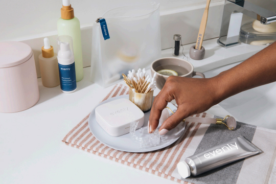Placing Invisalign Retainer on Tray in Bathroom Next to Sink