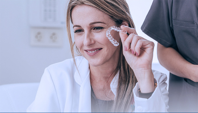 Dentist Holding Up Invisalign Retainer