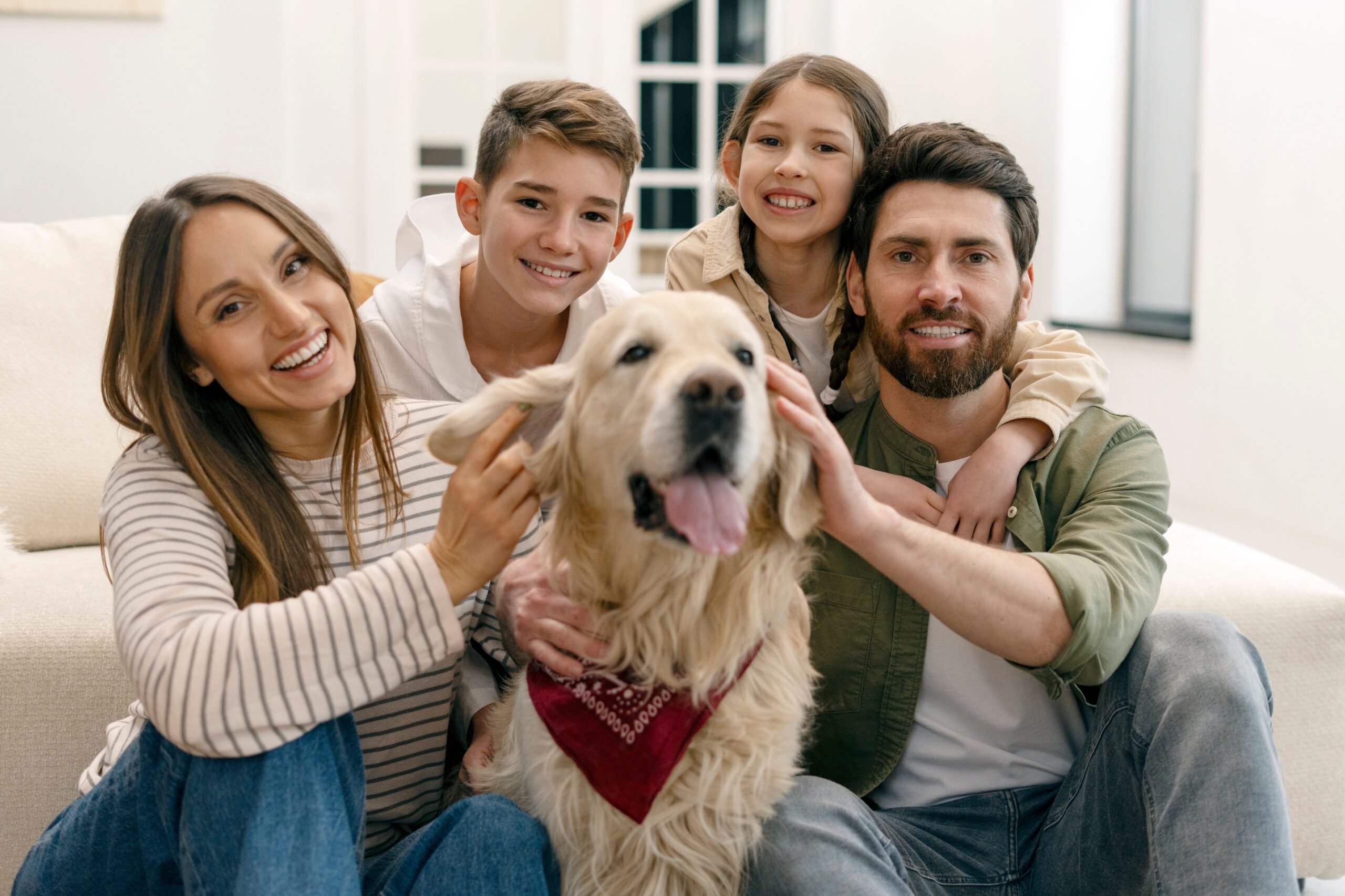 Smiling,Parents,And,Children,Are,Cuddling,Their,Adorable,Golden,Retriever